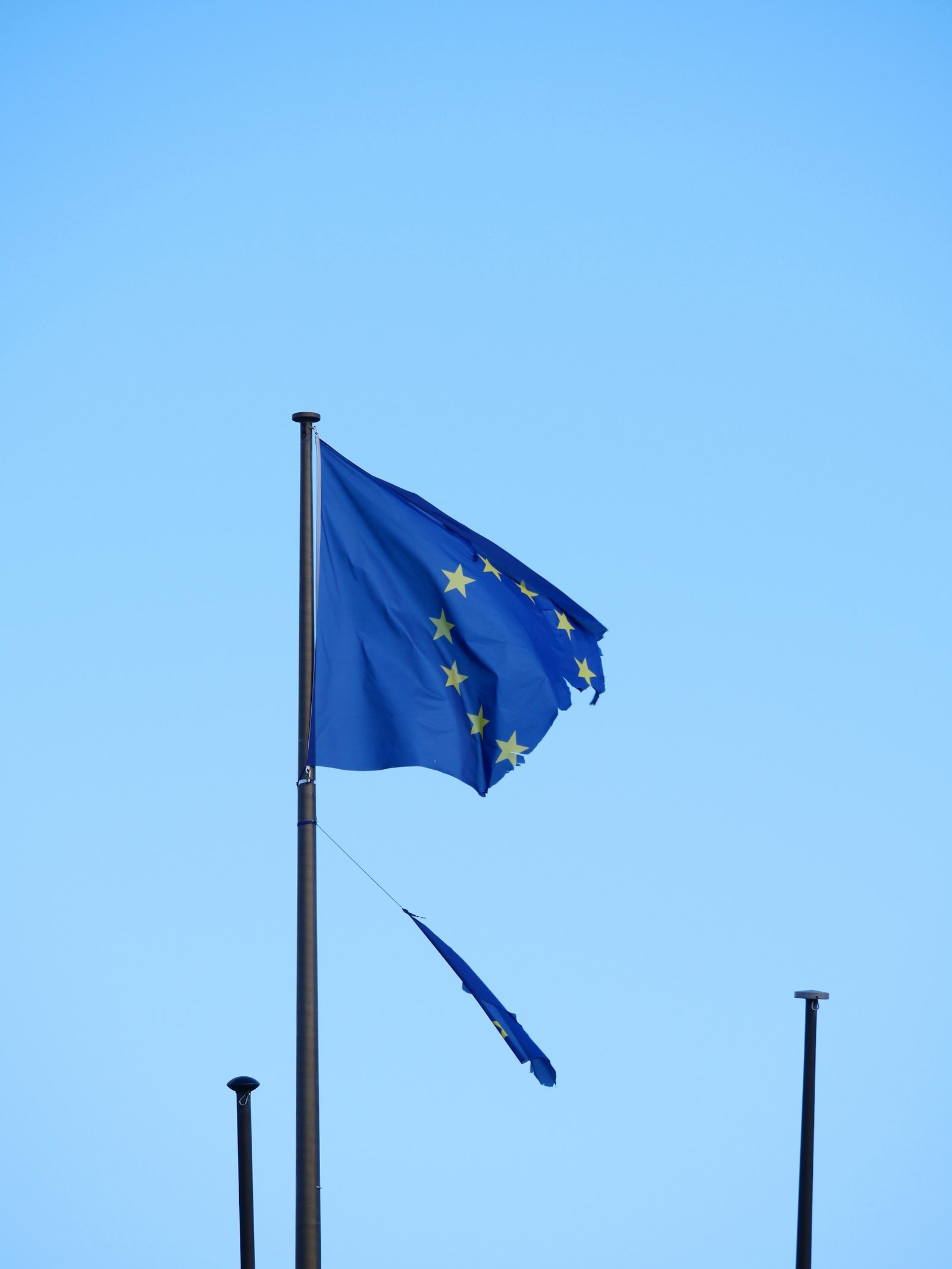 A European Union flag flying against the sky