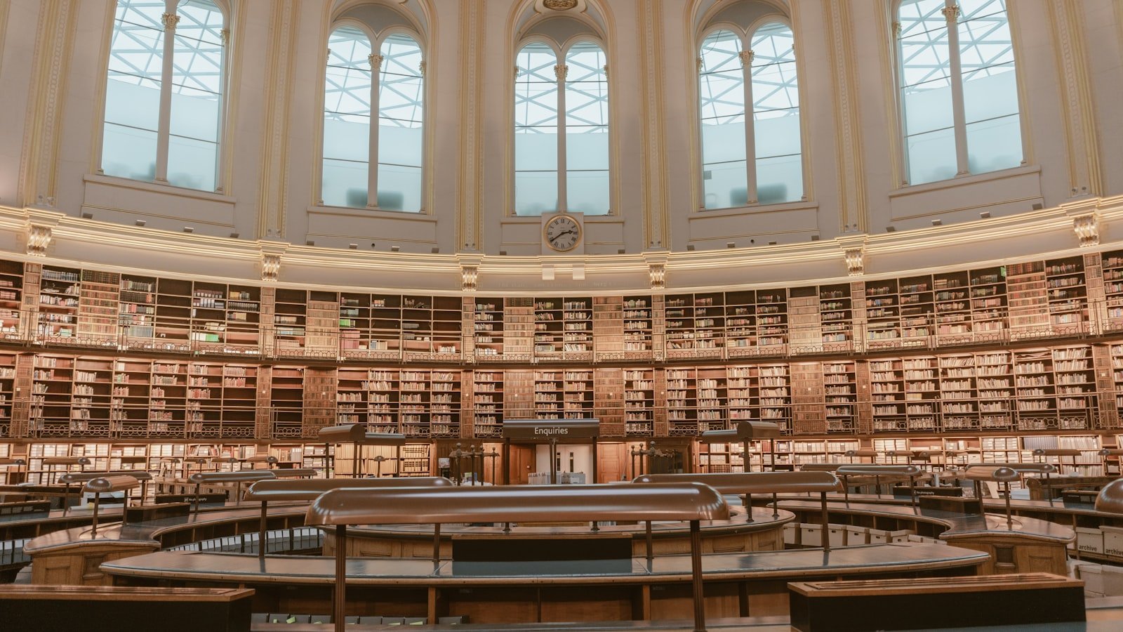 A grand circular library reading room lined with books